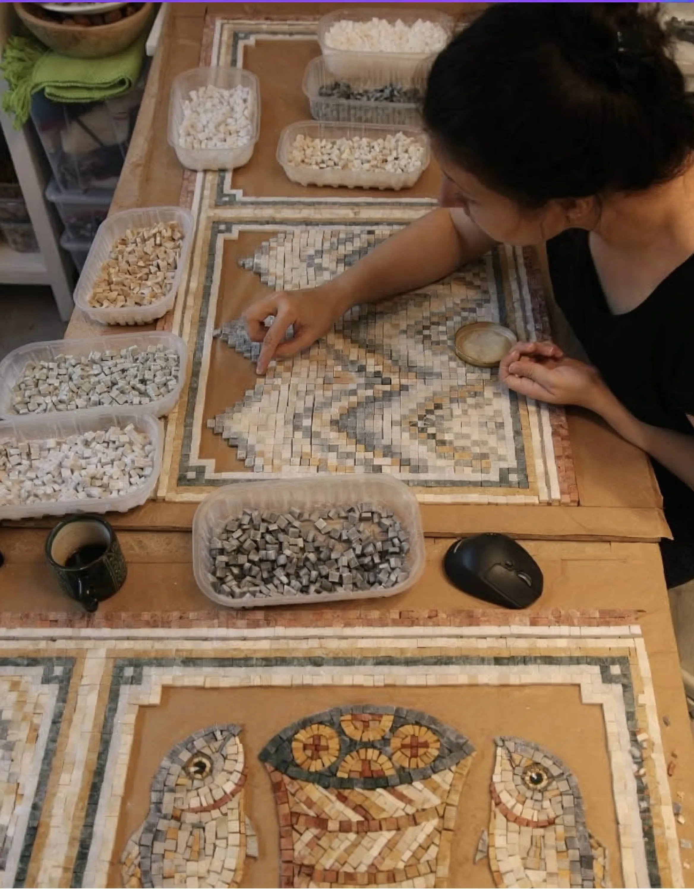An artisan working on a decorative stone mosaic